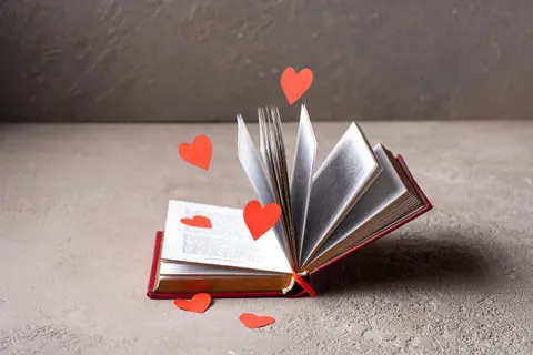 red-paper-hearts-fly-around-open-book-750